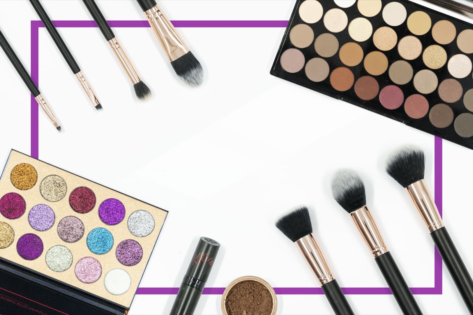 Clean product flat-lay of cosmetics, eyeshadow palettes and makeup brushes on a white background, styled for online store product photography